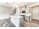 Modern kitchen with gray cabinets, white quartz countertops, and a large island at 4000 Cheyney Park Dr, Charlotte, NC 28269