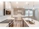 Modern kitchen with gray cabinets, white quartz countertops, and island at 4000 Cheyney Park Dr, Charlotte, NC 28269