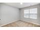 Well-lit bedroom featuring neutral walls and carpeted floors at 4004 Cheyney Park Dr, Charlotte, NC 28269