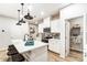 Modern kitchen with white cabinets, quartz countertops and island with seating at 4004 Cheyney Park Dr, Charlotte, NC 28269