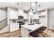 Modern kitchen with white cabinets, quartz countertops and island with seating at 4004 Cheyney Park Dr, Charlotte, NC 28269