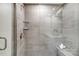 Spacious walk-in shower with glass enclosure and built-in seat at 4004 Cheyney Park Dr, Charlotte, NC 28269