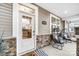 Inviting front entry with glass door and modern chairs on the porch at 4008 Cheyney Park Dr, Charlotte, NC 28269