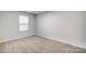 Simple bedroom with neutral wall colors and carpeted floor at 4012 Cheyney Park Dr, Charlotte, NC 28269