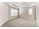 Well-lit bedroom featuring carpeted floors and tray ceiling at 4016 Cheyney Park Dr, Charlotte, NC 28269