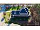 Aerial view of a brick home with a dark roof, lush lawn, and mature trees in a quiet neighborhood at 407 Blue Bay Ct, York, SC 29745
