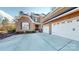 Lovely brick home with a three-car garage, surrounded by a pristine concrete driveway and lush landscaping at 407 Blue Bay Ct, York, SC 29745
