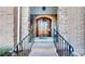 Inviting entryway with a stone archway leading to a beautiful wood double door, creating a warm welcome at 407 Blue Bay Ct, York, SC 29745