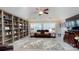 This living room features a ceiling fan, large windows and built-in bookshelves at 407 Blue Bay Ct, York, SC 29745