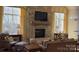 Cozy living room featuring a stone fireplace, plush seating, and natural light from nearby windows at 407 Blue Bay Ct, York, SC 29745