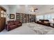 This spacious living room features built-in bookshelves and two leather sofas at 407 Blue Bay Ct, York, SC 29745