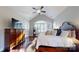 Bright main bedroom with hardwood floors, vaulted ceilings, a large bed, and ample natural light at 407 Blue Bay Ct, York, SC 29745