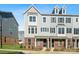 Three-story townhome with gray siding, brick accents, and a covered front porch at 4350 Reed Creek Dr, Sherrills Ford, NC 28673