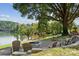 Lakefront fire pit with chairs under a large tree at 4350 Reed Creek Dr, Sherrills Ford, NC 28673