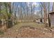 Large backyard with mature trees and a wooden fence at 4618 New Town Rd, Waxhaw, NC 28173