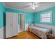 Bedroom with teal walls, wood floors, and a built-in closet at 4618 New Town Rd, Waxhaw, NC 28173