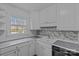 Well-lit kitchen showcasing white cabinets, stainless steel appliances, and a window with a view at 4618 New Town Rd, Waxhaw, NC 28173