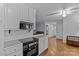 Modern kitchen with white cabinets, black appliances, and a view into the adjacent dining area at 4618 New Town Rd, Waxhaw, NC 28173