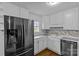 Clean kitchen with white cabinets, stainless steel appliances, and a window overlooking the backyard at 4618 New Town Rd, Waxhaw, NC 28173