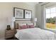 Bright bedroom with a queen-size bed, two nightstands, and large window at 504 Meadow Ridge Dr, Belmont, NC 28012