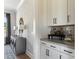 Modern wet bar with white cabinets and gray countertop at 504 Meadow Ridge Dr, Belmont, NC 28012