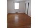 Comfortable bedroom features hardwood floors, white walls, and a bright window at 515 N Pine Ln, Wadesboro, NC 28170