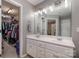 Double vanity bathroom with walk-in closet access at 5681 Berry Ridge Dr, Harrisburg, NC 28075