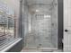 Modern bathroom with a large walk-in shower and built-in seat at 5681 Berry Ridge Dr, Harrisburg, NC 28075