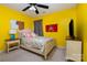 Bedroom with yellow walls, ceiling fan, and full-size bed at 5681 Berry Ridge Dr, Harrisburg, NC 28075