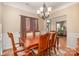 Bright dining room with hardwood floors and chandelier at 5681 Berry Ridge Dr, Harrisburg, NC 28075