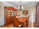 Formal dining room with hardwood floors, chandelier and china cabinet at 5681 Berry Ridge Dr, Harrisburg, NC 28075