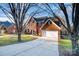 Two-story brick home with driveway and mature trees at 5681 Berry Ridge Dr, Harrisburg, NC 28075