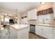 Kitchen boasts an island, stainless steel appliances, and ample cabinet space at 5681 Berry Ridge Dr, Harrisburg, NC 28075