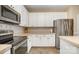 Kitchen with stainless steel appliances and tile countertops at 5681 Berry Ridge Dr, Harrisburg, NC 28075