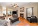 Living room with hardwood floors, fireplace and large windows at 5681 Berry Ridge Dr, Harrisburg, NC 28075