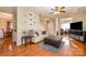 Living area with hardwood floors, fireplace and view to dining area at 5681 Berry Ridge Dr, Harrisburg, NC 28075