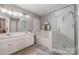 Main bathroom with double vanity, soaking tub, and walk-in shower at 5681 Berry Ridge Dr, Harrisburg, NC 28075