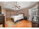 Spacious main bedroom with hardwood floors and ceiling fan at 5681 Berry Ridge Dr, Harrisburg, NC 28075