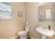 Clean powder room with pedestal sink and decorative mirror at 5681 Berry Ridge Dr, Harrisburg, NC 28075