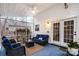 Relaxing screened porch with wicker furniture and ceiling fan at 5681 Berry Ridge Dr, Harrisburg, NC 28075