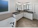 Double vanity bathroom with granite countertop and large tub at 6000 Bickett Ridge Dr, Monroe, NC 28110