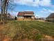 Brick house with a patio, set on a grassy hill at 6000 Bickett Ridge Dr, Monroe, NC 28110