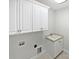 Laundry room with white cabinets and a utility sink at 6000 Bickett Ridge Dr, Monroe, NC 28110