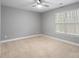 Spacious bedroom with neutral walls, carpet flooring, and a window with blinds at 6030 Sharon Hills Rd, Charlotte, NC 28210