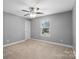 Bright bedroom featuring a ceiling fan and large window at 6030 Sharon Hills Rd, Charlotte, NC 28210