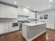 Modern kitchen featuring white cabinets, a center island, and hardwood floors at 6030 Sharon Hills Rd, Charlotte, NC 28210