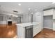 Open kitchen with island, stainless steel dishwasher, and hardwood floors at 6030 Sharon Hills Rd, Charlotte, NC 28210