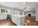 Open concept kitchen with island, stainless steel appliances, and views to the living room at 6030 Sharon Hills Rd, Charlotte, NC 28210