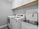 Laundry room with washer, dryer, cabinets, and sink at 6030 Sharon Hills Rd, Charlotte, NC 28210