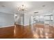 Open concept living area with hardwood floors, high ceilings, and kitchen view at 6030 Sharon Hills Rd, Charlotte, NC 28210